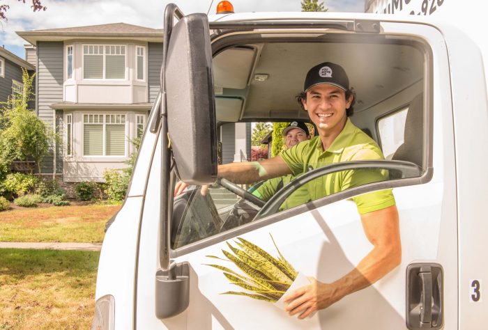 You Move Me St. Louis movers smiling in truck cab holding plant